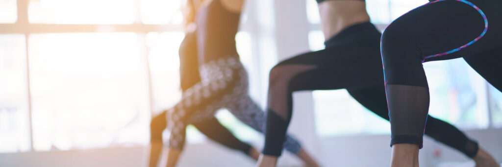 Women exercising in fitness studio yoga classes