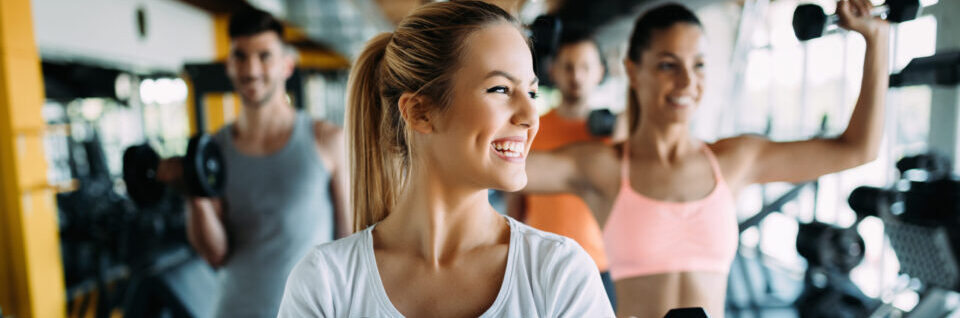 Picture of young cheerful fitness team in gym